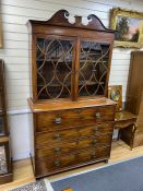 A Regency mahogany secretaire bookcase, fitted over with an earlier two door glazed cabinet, width