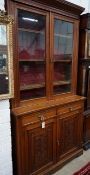 A late Victorian walnut bookcase cupboard, width 121cm, depth 48cm, height 236cm**CONDITION