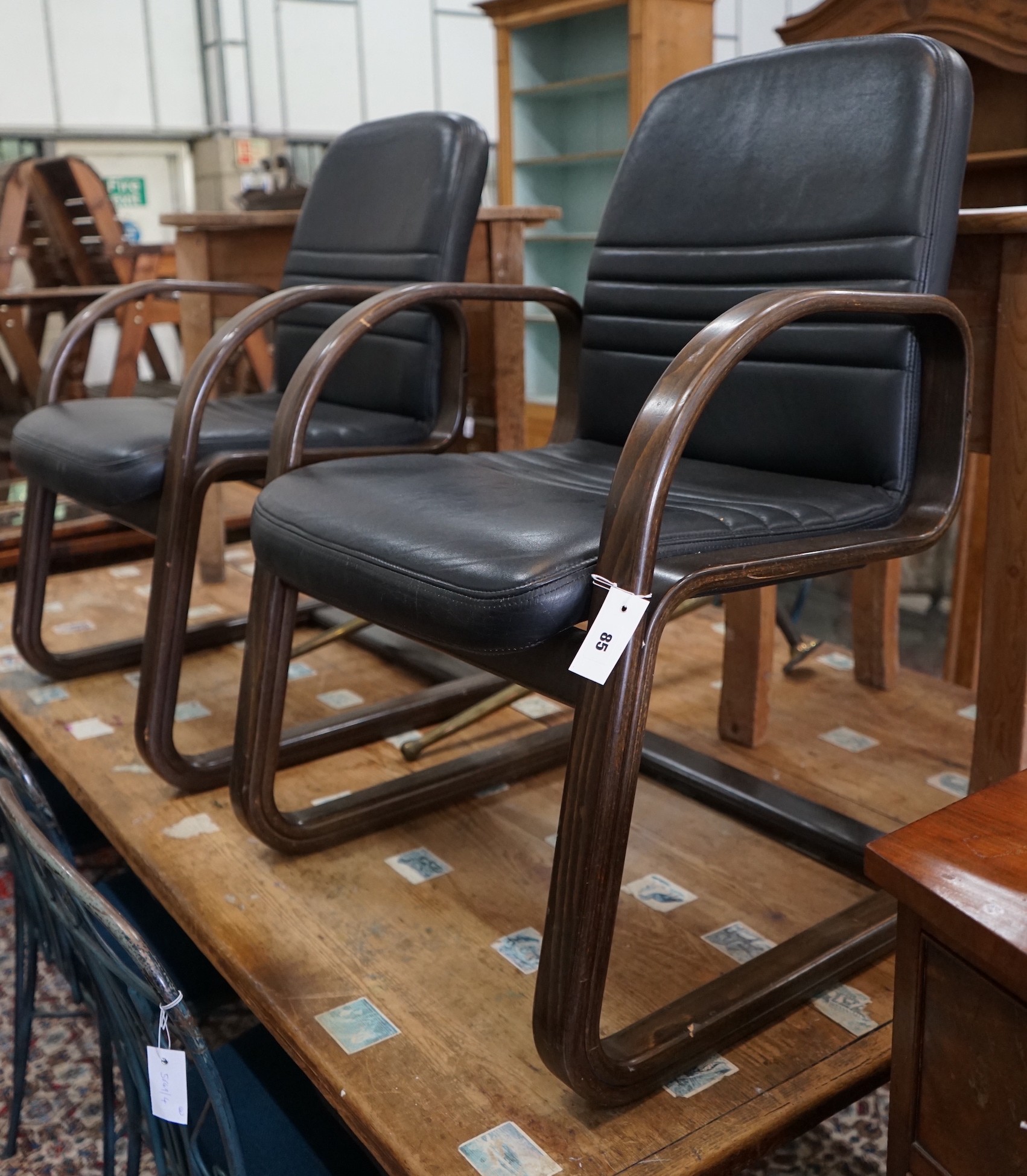 A pair of Sedus cantilever chairs, wood and black leather, width 60cm, depth 54cm, height 90cm**