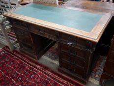 A late Victorian carved oak pedestal desk, length 137cm, depth 65cm, height 77cm**CONDITION
