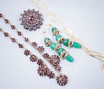 A Victorian gilt white metal and facetted garnet cluster set necklace, 42cm, a similar brooch, a