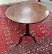 A George III mahogany circular tilt top tea table, with 'bird-cage' pillar and tripod supports,