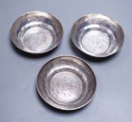 Three Persian engraved white metal finger bowls, (a.f.) diameter 10.6cm, 235 grams.**CONDITION
