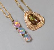 Two modern 9ct and opal set pendants, on 9ct gold chains, gross weight 10.6 grams.**CONDITION