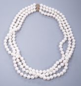 A modern triple strand cultured pearl set choker necklace, with 375 yellow metal clasp, 43cm.**