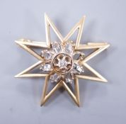 A yellow metal and diamond cluster set star brooch, 30mm, gross weight 6.6 grams.**CONDITION