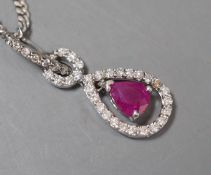 A modern white metal, ruby and diamond chip set pear shaped drop pendant, 20mm, on a 9ct white