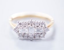 A modern 18ct gold, baguette and round cut diamond set shaped cluster ring, size O/P, gross weight