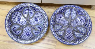 A pair of Moroccan metal bound pottery dishes, 39cm diameter**CONDITION REPORT**PLEASE NOTE:-