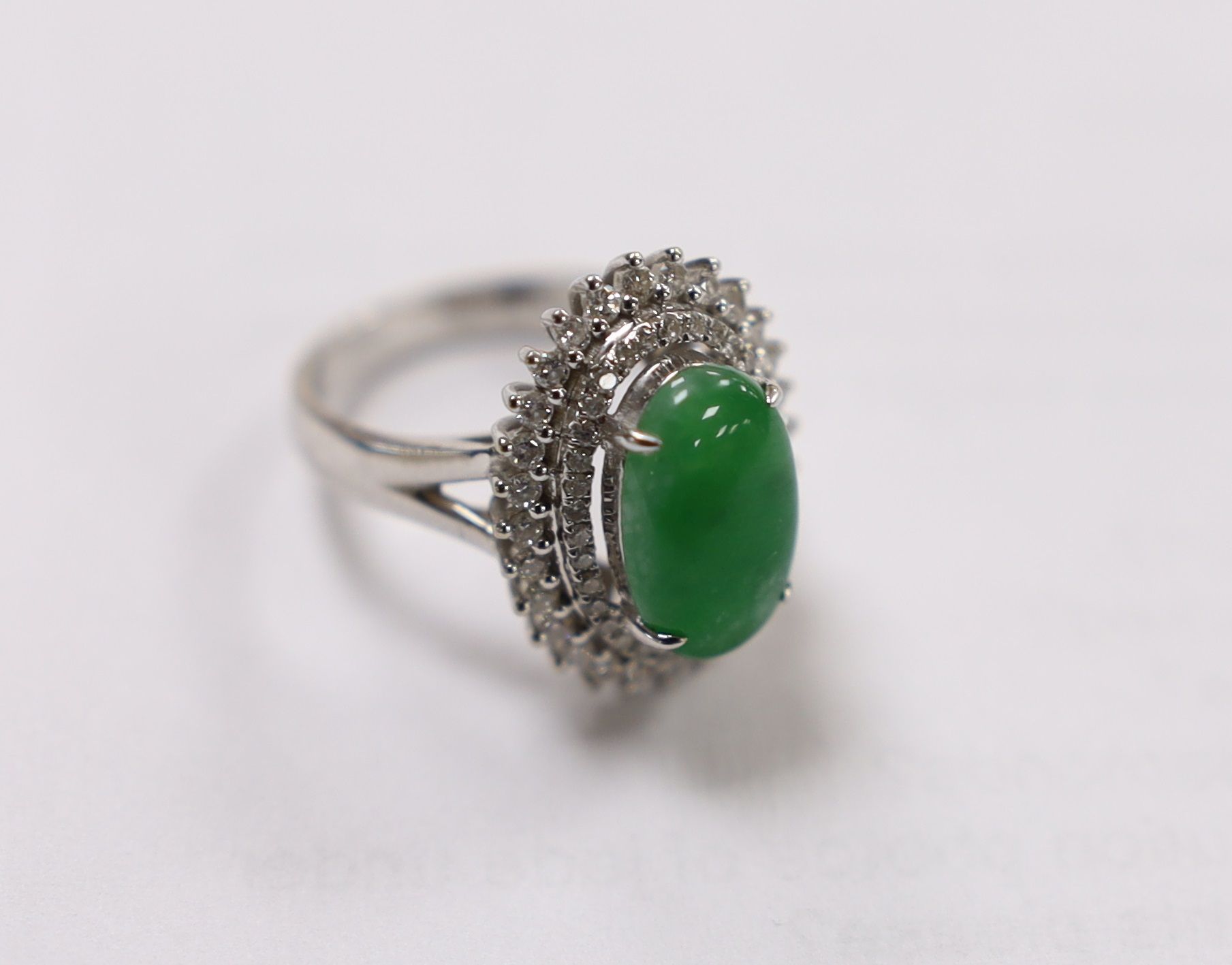 A modern 18k white metal, cabochon jade and two row diamond chip set oval cluster ring size L, gross - Image 5 of 8