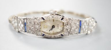 A lady's mid 20th century white metal, sapphire and diamond cluster set cocktail watch, on a 9ct