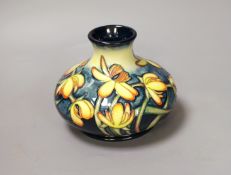 A Moorcroft pottery squat shaped vase, decorated with the "Celandine" pattern designed by Emma