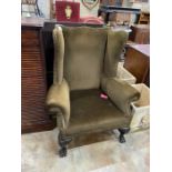 An early 20th century Georgian style upholstered wing armchair, width 92cm, depth 68cm, height