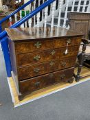 An 18th century feather banded walnut chest of two short and three graduating long drawers, width