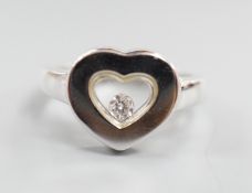 A modern 750 white metal and 'floating diamond' heart shape dress ring, size M, gross weight 6.4