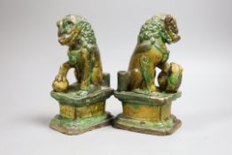 A pair of Chinese sancai lion dog joss-stick holders, late Ming dynasty,20cm high,