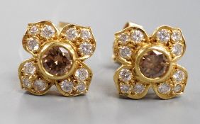 A modern pair of 750 yellow metal and two colour diamond cluster set earrings, 9mm, gross weight 4.1