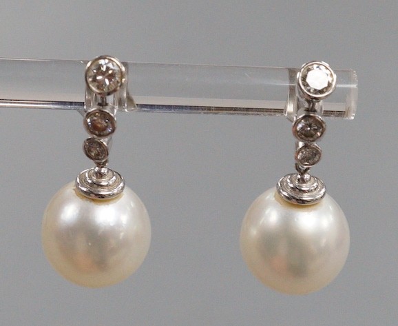 A modern pair of 750 white metal, singe stone South Sea pearl and graduated three stone diamond - Image 2 of 5