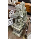 A pair of reconstituted stone cherub and dove garden ornaments on faux marble plinths, height 116cm