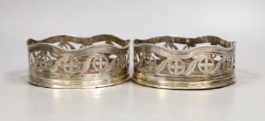 A pair of George III pierced silver wine coasters, maker's mark rubbed, London, 1787,diameter 12.