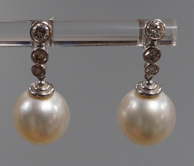 A modern pair of 750 white metal, singe stone South Sea pearl and graduated three stone diamond - Image 3 of 5