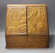 An Edwardian oak two door stationary box,36 cms high,
