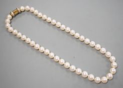 A cased modern single strand Akoya cultured pearl necklace, with diamond chip set 750 yellow metal