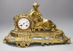 A 19th century French gilt metal figural mantel clock, with porcelain floral panels,30cms high.