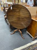 A George III and later circular mahogany tilt top tea table with birdcage alignment, diameter