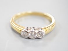 A modern 18ct gold and collet set three stone diamond ring, size P, gross weight 3.6 grams, total