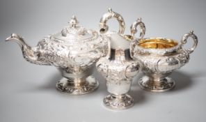 A matched Victorian embossed silver inverted pear shaped three piece tea set, teapot James Mackay,