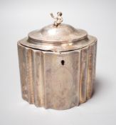 A George III engraved silver shaped oval tea caddy, the finial modelled as a seated oriental figure,