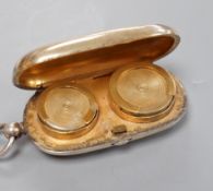 A George V silver silver gilt oval sovereign/half sovereign case, with engraved initials, Goldsmiths