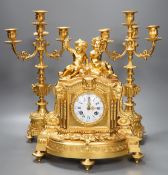 A Louis XVI style ormolu ‘cherub’ clock garniture, late 19th century, with pendulum, 43cm tall