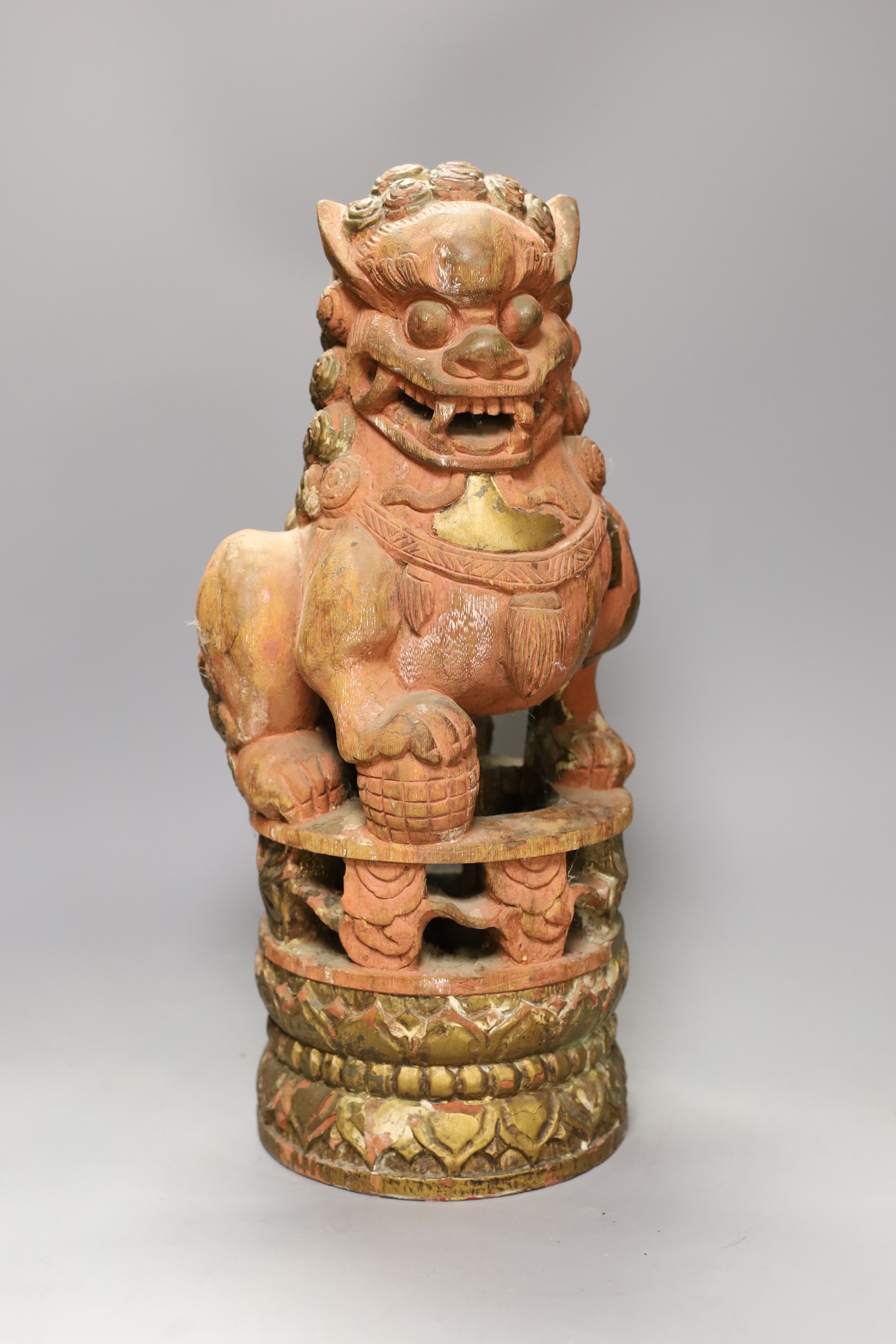 A South East Asian painted wood Buddhist lion
