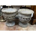 A pair of circular reconstituted stone garden planters, diameter 39cm, height 44cm