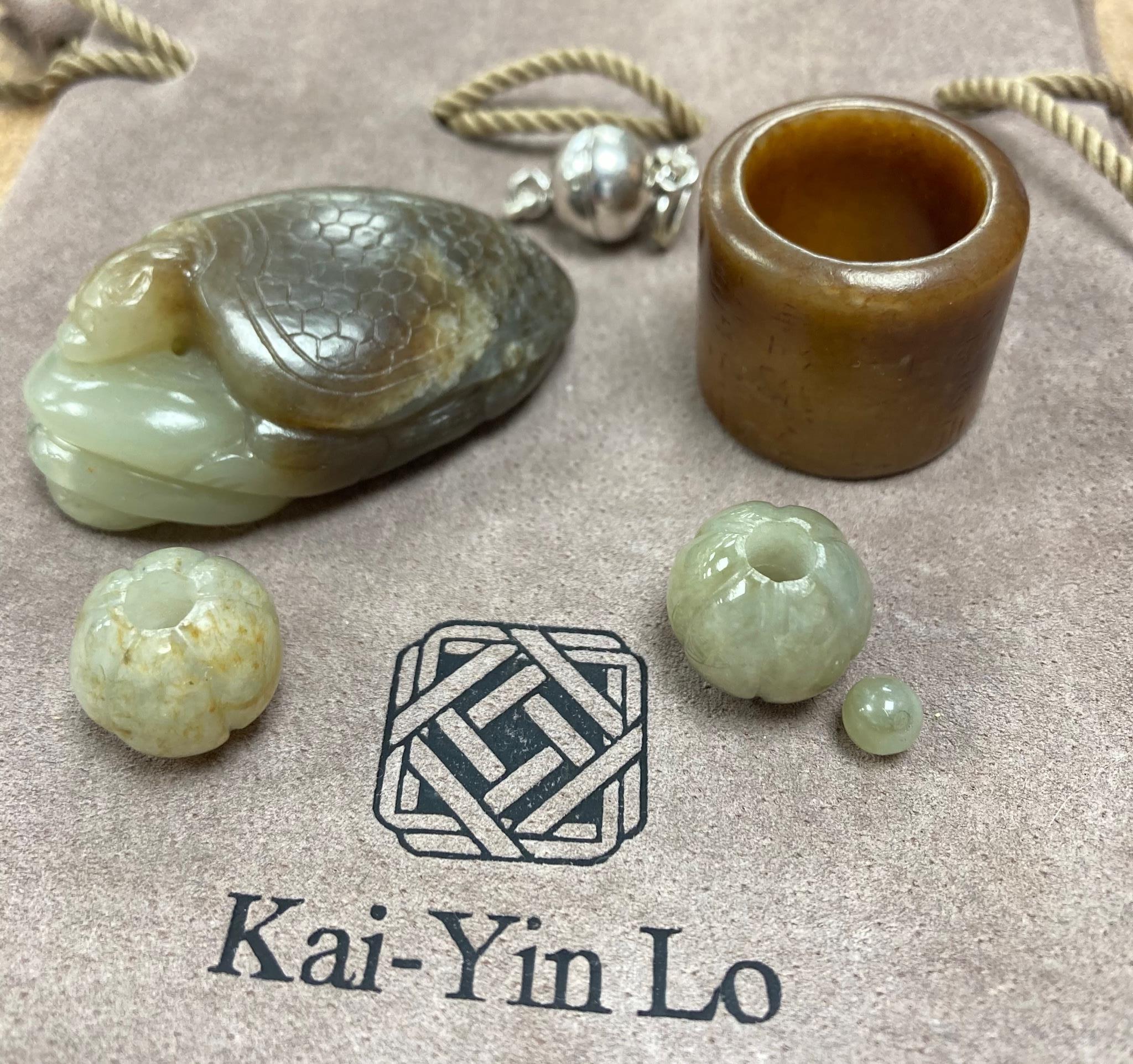 Kai Yin Lo of Hong Kong, a jade turtle and snake pendant, jade archer’s ring and two beads, formerly