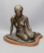 Audrey Shaw. A bronzed resin figure of a seated girl,43cm tall,