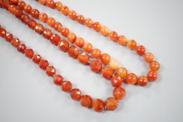 Two single strand carnelian necklace, one with facet cut beads, 44cm & 60cm, both with yellow