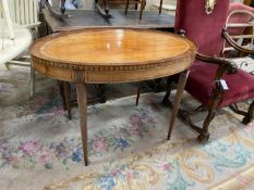 A George III Sheraton style oval banded satinwood centre table fitted drawer on square tapered legs,
