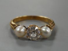 A yellow metal, cultured pearl and diamond set three stone ring, size L, gross weight 3 grams, the