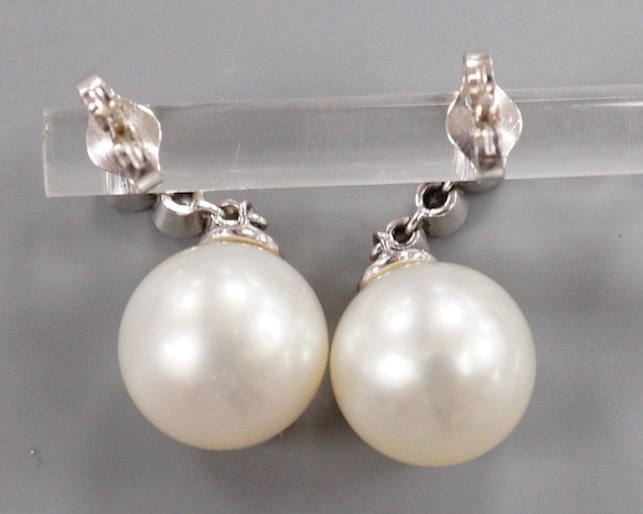 A modern pair of 750 white metal, singe stone South Sea pearl and graduated three stone diamond - Image 5 of 5