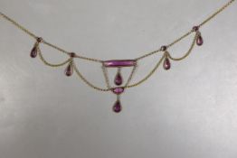 An early 20th century gilt metal and amethyst paste set drop fringe necklace, approx. 46cm.