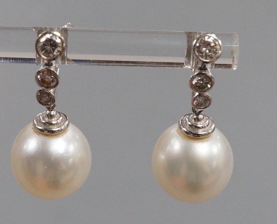 A modern pair of 750 white metal, singe stone South Sea pearl and graduated three stone diamond - Image 4 of 5