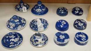 Twelve 18th/19th century Chinese blue and white ‘prunus’ vase and jar covers, largest 17 cm