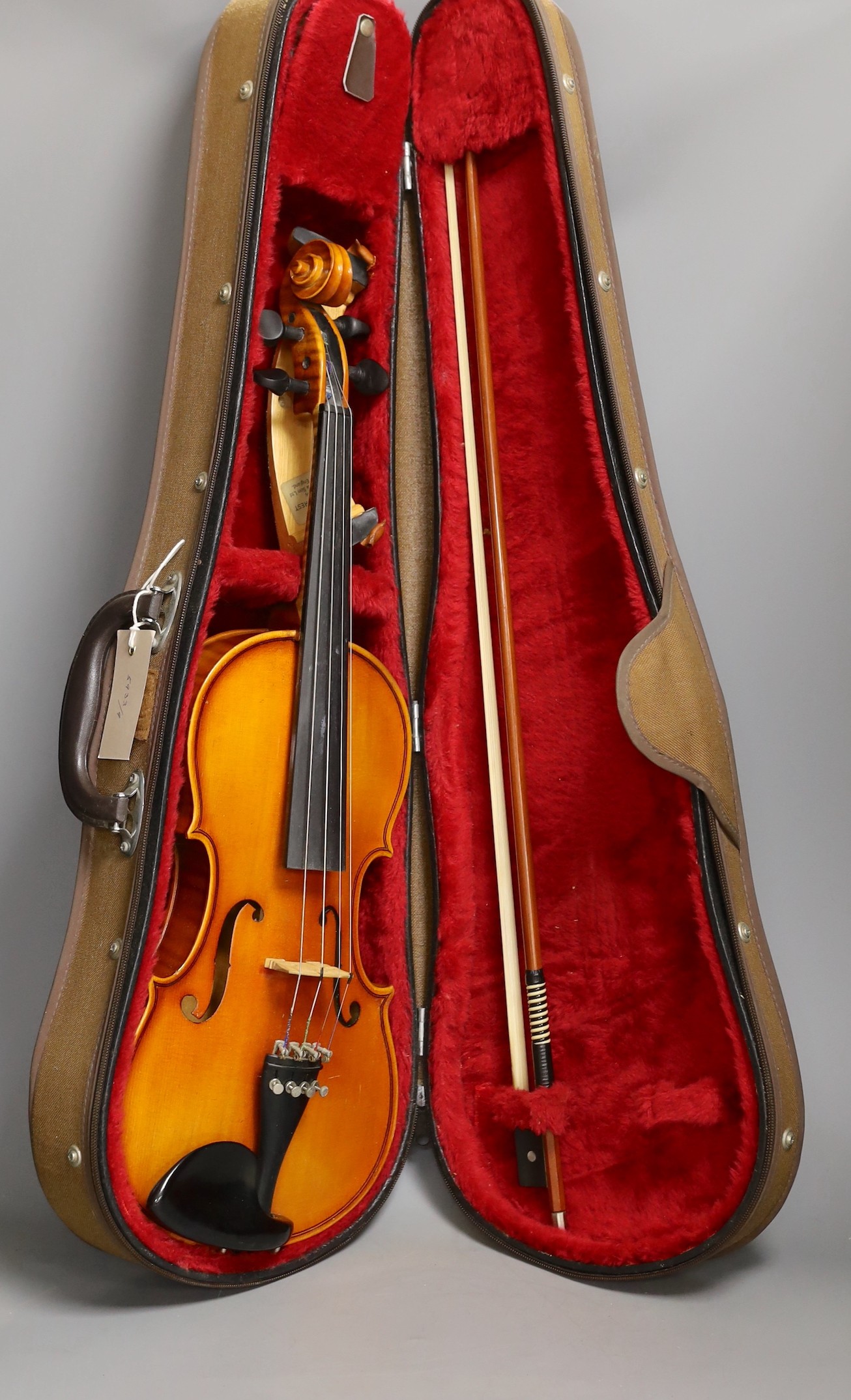 A cased child's violin and bow with ivorine tip, violin 55cms long,