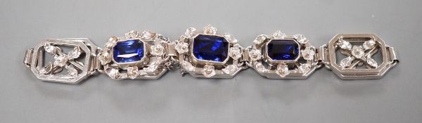 A modern 9ct white metal and three stone emerald cut sapphire set pierced link bracelet, approx.