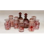 A pair of 19th century wheel engraved ruby glass decanters with stoppers, and seven ruby stained