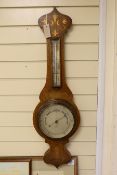 An Art Nouveau inlaid wheel barometer, by Dixey of Brighton, 93cm tall
