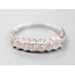A modern platinum and seven stone princess cut diamond set half hoop ring, size M/N, gross weight